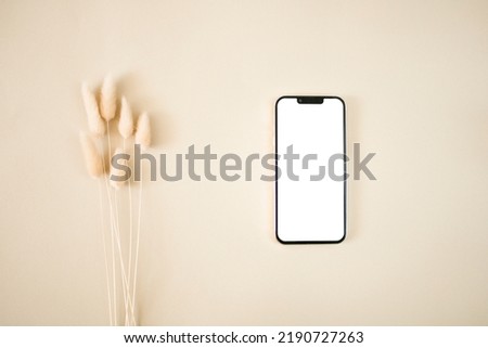 Top view botanical mobile mockup with flowers on beige background