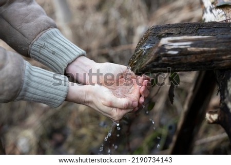 Washing Hands and Drinking Water From Natural Source Outdoors