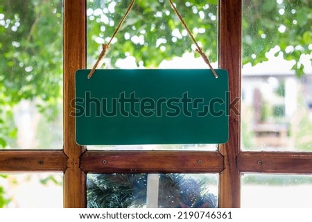 Blank sign on the wooden door in front of the cafe. Copy space background