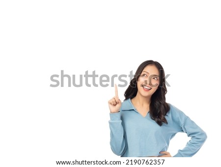 Happy young Asian woman looking above and pointing up to copy space with smile face and happy Pretty girl act like a satisfied product, use for advertising with isolated on white background