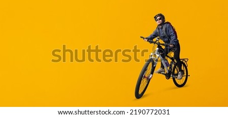  Cyclist woman riding a bike isolated on yellow background, Clipping paths for design work empty free space                            Royalty-Free Stock Photo #2190772031