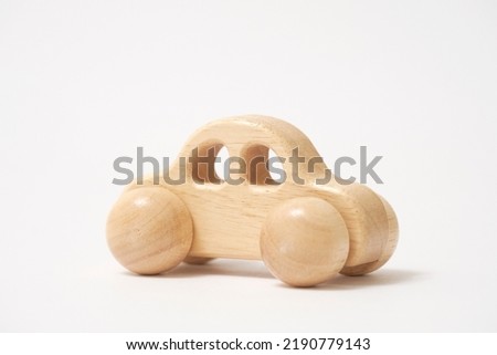The wooden miniature car in white background Royalty-Free Stock Photo #2190779143