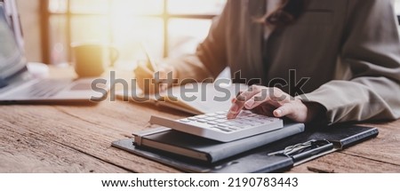 The financiers are calculating personal taxes for their customers. Royalty-Free Stock Photo #2190783443