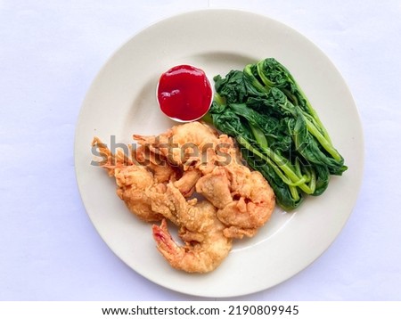 Fresh Fried Shrimps with Boiled Green Mustard and Tomato Sauce on White Plate