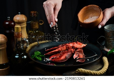 Seafood. Lobster claws on a plate in the hands of the chef. Food banner. Royalty-Free Stock Photo #2190813261