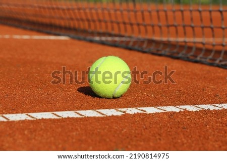 Symbol image tennis: Close-up of a tennis ball on a clay court