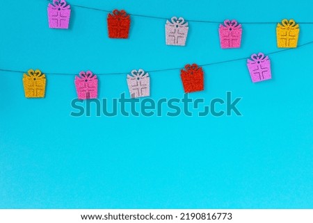 New Year's garland of gifts on a light blue background. Ideas for your design. New Year and Christmas background