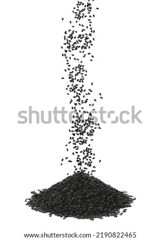 Black sesame seeds falling into pile on white background Royalty-Free Stock Photo #2190822465
