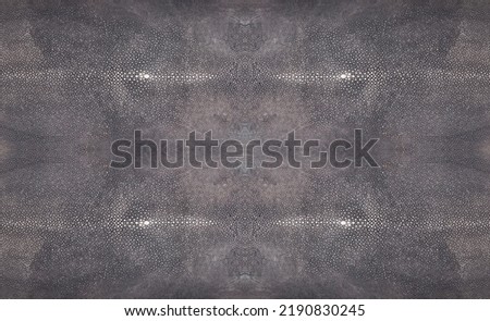 Tanned grey raw exotic rectangle stingray skin isolated on white background
