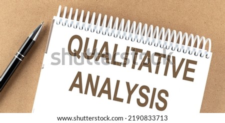 QUALITATIVE ANALYSIS text on notepad with pen, business concept Royalty-Free Stock Photo #2190833713