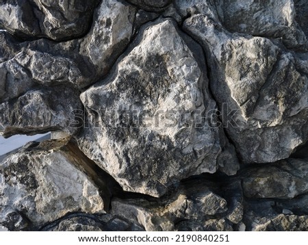 Texture of a large ancient stone. Photographed in the afternoon.