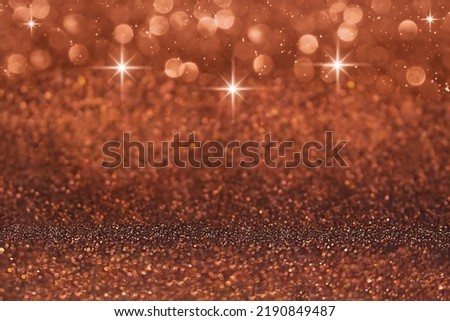 Red, brown defocused shiny with stars and glitter, shimmer and sparkle background. Christmas, New Year. Copy space