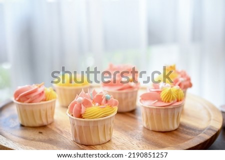 Tasty yummy homemade cupcake on a wooden tray. Sweets and dessert concept. close-up image