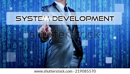 Business man with digital background pressing on button system development