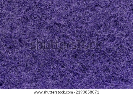 Background, photo texture from purple synthetic fiber, close-up.