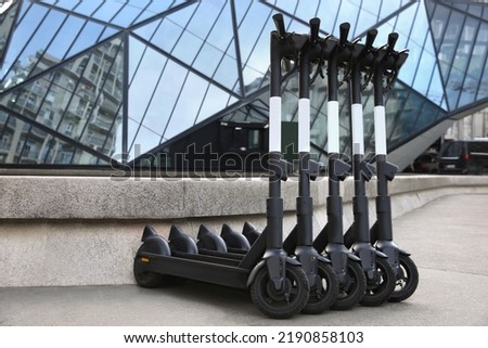 Row of electric scooters on city street. Rental service Royalty-Free Stock Photo #2190858103