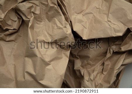 crumpled brown kraft paper background. Recycle old brown paper texture