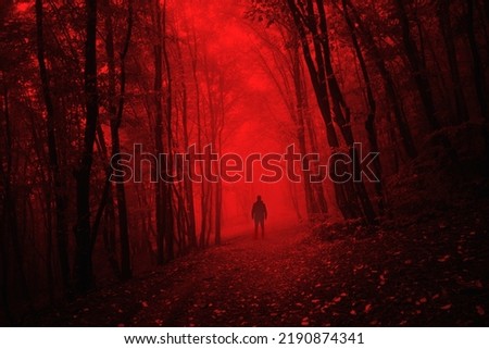 man in dark scary forest on halloween night Royalty-Free Stock Photo #2190874341