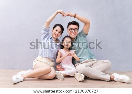 Young Asian family sitting on the floor Royalty-Free Stock Photo #2190878727