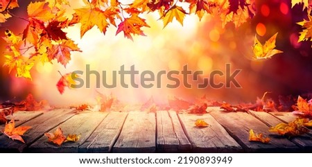 Autumn - Wooden Table With Orange Leaves And At Sunset In Defocused Abstract Background