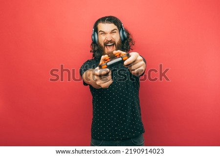 A photo of a man agressively playing video games