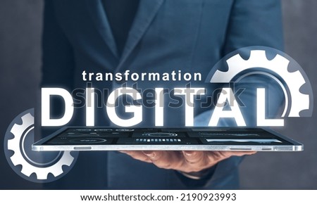 digital transformation. businessman holds in his hand tablet with text digital transformation and gears. Digital modernization and business processes to modern computer technologies Royalty-Free Stock Photo #2190923993