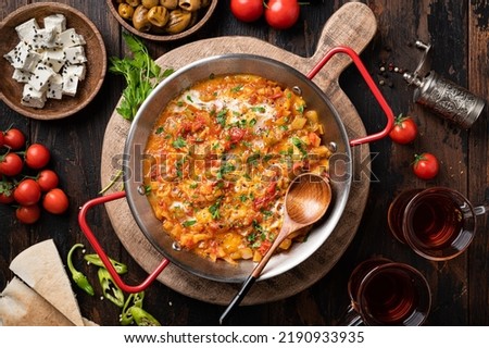 Menemen, Turkish breakfast, eggs with peppers and tomatoes, top view Royalty-Free Stock Photo #2190933935