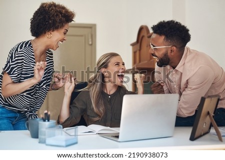 Happy, smiling and cheering young university or college students excited after completing a project. Casual team of learners celebrating after getting a good grade on a their research assignment Royalty-Free Stock Photo #2190938073
