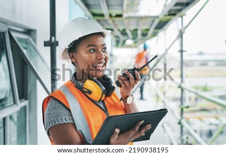 Construction worker with tablet, walkie talkie or radio talking, instructing and checking building progress on development site. Architect manager, female leader or engineer watching infrastructure Royalty-Free Stock Photo #2190938195