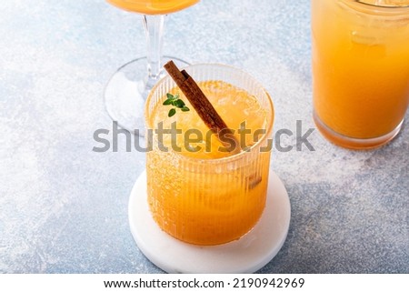 Variety of fall cocktails or mocktails made with apple cider in a light and bright setting, Thanksgiving drinks ideas