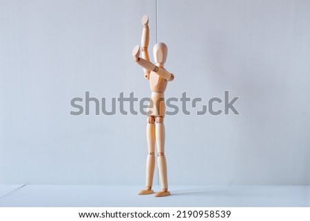Concept of making the stop signal with the figure of a wooden boy