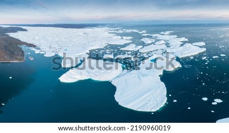 Glaciers drone aerial image from above - climate change and global warming. Glaciers from a melting iceberg in Ilulissat, Greenland. The icy landscape of the Arctic nature in the UNESCO world Royalty-Free Stock Photo #2190960019