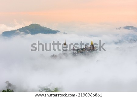 Biggest whit Buddha in the temple on top of mountain is one of best landmarks of Thailand with sea of fog cover around on the morning. Royalty-Free Stock Photo #2190966861