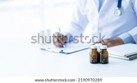 Online medical consultation doctor working on laptop computer in clinic office, healthcare, medical service, consultation or education, healthy lifestyle concept