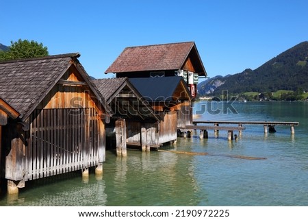 Wolfgangsee mountain lake in Austrian Alps. Austria landscape in Salzkammergut region. Historic wooden boathouses. Royalty-Free Stock Photo #2190972225