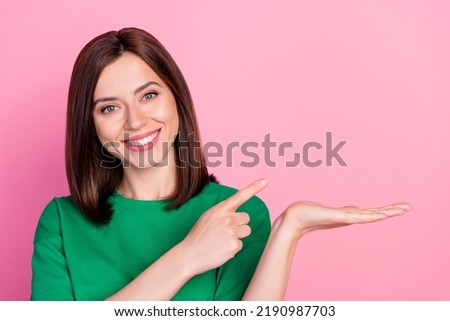 Closeup photo of young smiling woman hold hand new product advertisement recommend isolated on pink color background Royalty-Free Stock Photo #2190987703