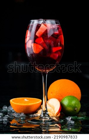 sangria with red wine, apple and orange, Sangria in glass on dark background Royalty-Free Stock Photo #2190987833