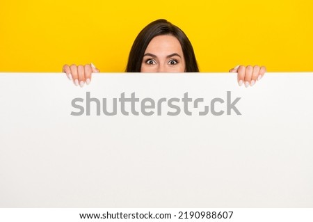 Photo portrait of lovely young woman hiding behind white wall blank space wear stylish striped outfit isolated on yellow color background Royalty-Free Stock Photo #2190988607