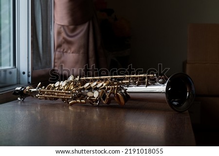 Soprano Saxophone Mouthpiece, Closeup Woodwind Instrumental Equipment on Blur Saxophone Background. Royalty-Free Stock Photo #2191018055
