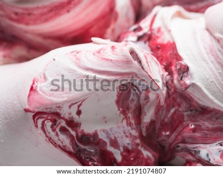 Frozen Cherry flavour gelato - full frame detail. Close up of a white surface texture of Ice cream covered with red stripes.