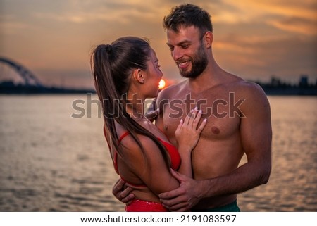 Couple in love having romantic tender moments at sunset on the beach - Young lovers having tender moments in summer vacation - Love concept. Selective focus Royalty-Free Stock Photo #2191083597