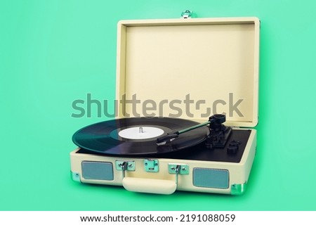 Vintage vinyl record player isolated on green background Royalty-Free Stock Photo #2191088059