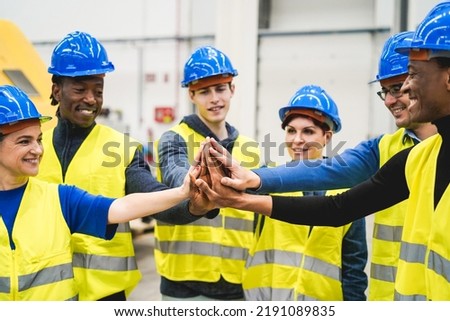Multiracial engineers stacking hands inside robotic factory - Focus on hands