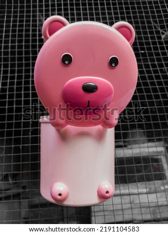 Selective focus pink cute stuffed dog plastic toy