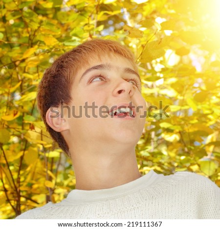 Toned photo of Cheerful Teenager in the Autumn Park