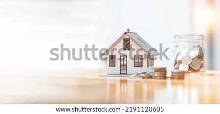 house model and money coins saving for concept saving money for buying a house, investment mortgage finance, and home loan refinance financial plan home loan. Royalty-Free Stock Photo #2191120605