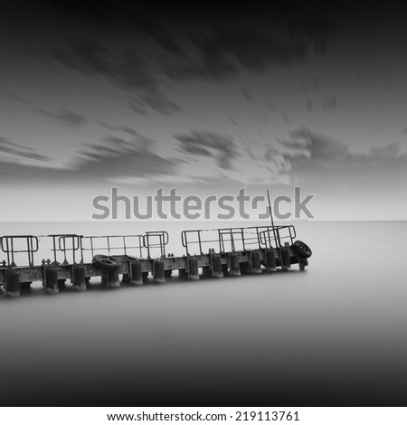 Black and white seascape with metal pier in the sea and beautiful sky, Black sea, Odessa, Ukraine