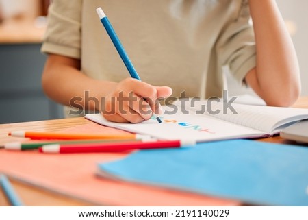 Student drawing picture in book, learning math and doing calculations in a notebook for education in a classroom at school. Little child writing, being creative with numbers and studying in class