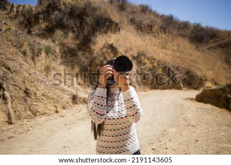 tourist woman taking pictures with a professional dslr camera. Travel, tourism and lifestyle concept.