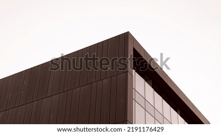 Modern office building exterior with glass facade on clear sky background. Vivid colors Transparent glass wall of office building with red pink decoration. Element of facade of modern European Royalty-Free Stock Photo #2191176429